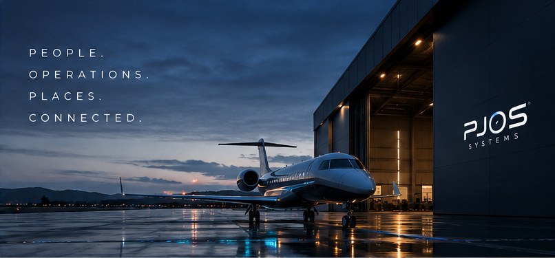 A private jet on a wet ramp at dusk beside a dark hangar